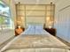 Bright bedroom with large window, wall paneling, and mid-century dresser at 9095 Sommerset Hills Dr, Davenport, FL 33896