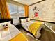 Mickey Mouse themed bedroom with two twin beds and yellow accents at 9095 Sommerset Hills Dr, Davenport, FL 33896