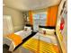 Mickey Mouse themed bedroom with two twin beds and yellow accents at 9095 Sommerset Hills Dr, Davenport, FL 33896