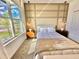 Bright bedroom with large window, wall paneling, and mid-century dresser at 9095 Sommerset Hills Dr, Davenport, FL 33896