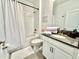 Clean bathroom with a tub shower combo, white vanity, and grey flooring at 9095 Sommerset Hills Dr, Davenport, FL 33896