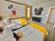 Mickey Mouse themed bedroom with two twin beds and yellow accents at 9095 Sommerset Hills Dr, Davenport, FL 33896