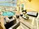 Enclosed pool and spa with lounge chairs and a seating area at 9095 Sommerset Hills Dr, Davenport, FL 33896