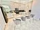 Modern kitchen with white cabinets, gray countertops, and island seating at 9095 Sommerset Hills Dr, Davenport, FL 33896