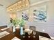 Elegant dining room featuring a long table and modern chandelier at 9095 Sommerset Hills Dr, Davenport, FL 33896