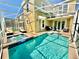 Enclosed pool and spa with lounge chairs and a seating area at 9095 Sommerset Hills Dr, Davenport, FL 33896