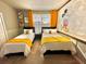 Mickey Mouse themed bedroom with two twin beds and yellow accents at 9095 Sommerset Hills Dr, Davenport, FL 33896