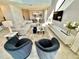 Bright living room features two velvet armchairs and a large sectional sofa at 9095 Sommerset Hills Dr, Davenport, FL 33896