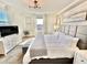 Spacious primary bedroom with large bed, TV, and plenty of natural light at 9095 Sommerset Hills Dr, Davenport, FL 33896