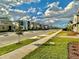 Street view of modern houses with landscaping and a clear sky at 9095 Sommerset Hills Dr, Davenport, FL 33896