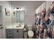 Bathroom with flamingo shower curtain and single vanity at 1138 Knollwood Dr, Davenport, FL 33837