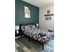 Bedroom with full-size bed and dark-green accent wall at 1138 Knollwood Dr, Davenport, FL 33837