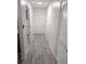 Long entryway with light gray wood-look flooring at 1250 S Denning Dr # 122, Winter Park, FL 32789