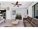 Bright living room with sectional sofa, coffee table, and view into the kitchen area at 8930 Sydney Ave, Kissimmee, FL 34747
