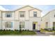 Two-story house with light-colored siding and blue shutters at 8930 Sydney Ave, Kissimmee, FL 34747