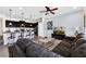 Open concept kitchen and living room with dark cabinetry, granite countertops, and comfortable seating at 8930 Sydney Ave, Kissimmee, FL 34747