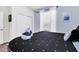 Bedroom with a queen bed, white closet, and gray flooring at 8930 Sydney Ave, Kissimmee, FL 34747