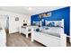Guest bedroom with two twin beds and blue accent wall at 8930 Sydney Ave, Kissimmee, FL 34747