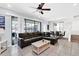 Relaxing living room with L-shaped sectional and access to a screened patio at 8930 Sydney Ave, Kissimmee, FL 34747