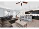 Open floor plan features a kitchen with island and a living room with sectional sofa at 8930 Sydney Ave, Kissimmee, FL 34747