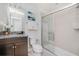 Bathroom with granite countertop, dark brown vanity, and shower at 8930 Sydney Ave, Kissimmee, FL 34747