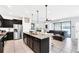 Open kitchen with granite countertops and stainless steel appliances at 8930 Sydney Ave, Kissimmee, FL 34747