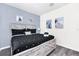 Main bedroom with a king-size bed and beach decor at 8930 Sydney Ave, Kissimmee, FL 34747