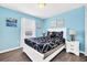 Bedroom with a queen bed and coastal decor at 8930 Sydney Ave, Kissimmee, FL 34747
