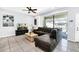 Spacious living area featuring a sectional sofa, coffee table, and a flat-screen TV at 8930 Sydney Ave, Kissimmee, FL 34747