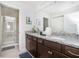 Double vanity bathroom with granite countertop and shower at 8930 Sydney Ave, Kissimmee, FL 34747