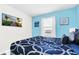 Bedroom with a king-size bed and a wall-mounted TV at 8930 Sydney Ave, Kissimmee, FL 34747