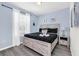 Main bedroom with king-size bed, light walls, and stylish nightstand at 8930 Sydney Ave, Kissimmee, FL 34747