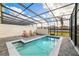 Private screened pool and spa with lounge chairs at 8930 Sydney Ave, Kissimmee, FL 34747
