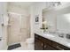 Bathroom with granite countertop, dark brown vanity, and shower at 8930 Sydney Ave, Kissimmee, FL 34747