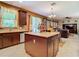 Kitchen island with granite countertop and dark wood cabinets at 1382 Plumgrass Cir, Ocoee, FL 34761