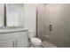 Bathroom with granite countertop, toilet and glass shower at 487 Toscano St, Clermont, FL 34715