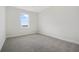 Well-lit bedroom featuring neutral wall paint and carpet at 487 Toscano St, Clermont, FL 34715