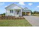 Charming farmhouse style home with a spacious covered porch and attached two-car garage at 487 Toscano St, Clermont, FL 34715