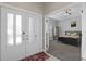Bright entryway with double doors and view into bedroom at 900 Sussex Close, Orlando, FL 32804