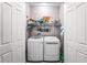 Laundry closet with washer, dryer, and ample storage shelves at 610 Celebration Ave # 1209, Celebration, FL 34747