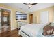 Main bedroom with king bed, en-suite bathroom access, and hardwood floors at 610 Celebration Ave # 1209, Celebration, FL 34747