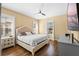 Bright bedroom with a king-size bed, hardwood floors, and plenty of natural light at 610 Celebration Ave # 1209, Celebration, FL 34747