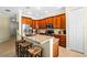 Kitchen with wood cabinets, granite countertops, and island with seating at 610 Celebration Ave # 1209, Celebration, FL 34747