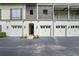 Building exterior with multiple garages and private entryways at 610 Celebration Ave # 1209, Celebration, FL 34747