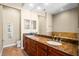 Double vanity bathroom with marble countertop and wood cabinets at 610 Celebration Ave # 1209, Celebration, FL 34747