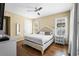 Spacious main bedroom with a king-size bed and hardwood floors at 610 Celebration Ave # 1209, Celebration, FL 34747