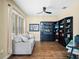 Bright home office features built-in shelving, hardwood floors, and a comfortable couch at 610 Celebration Ave # 1209, Celebration, FL 34747
