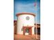 Exterior view of a circular post office building with a flagpole at 610 Celebration Ave # 1209, Celebration, FL 34747