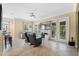Open living space with comfortable seating, a large TV, and balcony access at 610 Celebration Ave # 1209, Celebration, FL 34747