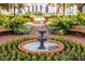 Ornate fountain in a landscaped courtyard with benches at 610 Celebration Ave # 1209, Celebration, FL 34747